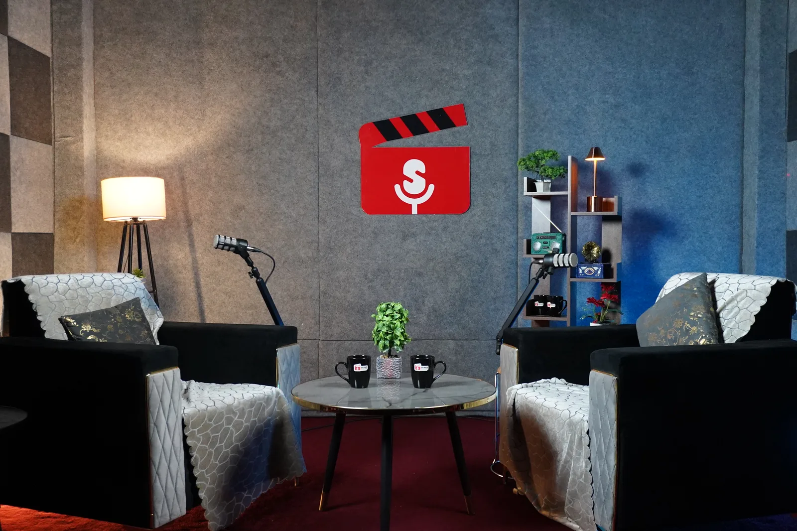 Podcast recording set with armchairs and acoustic panels at Urban Digital Studio Nashik